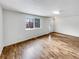 Bright living room featuring hardwood floors, a large window, and a modern ceiling light at 3061 W 92Nd Ave # 11B, Westminster, CO 80031