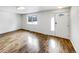 Bright living room with wood flooring, a large window, and a white front door at 3061 W 92Nd Ave # 11B, Westminster, CO 80031