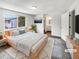 Bright, staged main bedroom featuring a large window and ensuite bathroom access for convenience at 3061 W 92Nd Ave # 11B, Westminster, CO 80031