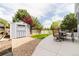 Landscaped backyard with patio, outdoor furniture, shed, gravel area, and privacy fence at 15389 E 99Th Way, Commerce City, CO 80022