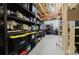 Unfinished basement with exposed ceiling and organized storage shelves and containers at 15389 E 99Th Way, Commerce City, CO 80022