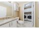 Bathroom with a stylish vanity and a laundry room featuring a washer and dryer at 15389 E 99Th Way, Commerce City, CO 80022