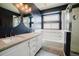 Beautiful bathroom with double sinks, modern lighting, and soaking tub at 15389 E 99Th Way, Commerce City, CO 80022