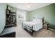 Cozy bedroom with green walls, a queen-sized bed, a window, and a carpeted floor at 15389 E 99Th Way, Commerce City, CO 80022