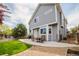 Home exterior featuring a patio with outdoor dining set, backyard with a small grassy area at 15389 E 99Th Way, Commerce City, CO 80022