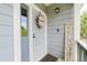 Charming entryway with a decorative wreath and welcome sign, creating a warm and inviting first impression at 15389 E 99Th Way, Commerce City, CO 80022
