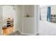 Hallway leading to a carpeted bedroom and a view of the kitchen at 15389 E 99Th Way, Commerce City, CO 80022