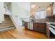 Open kitchen with stainless appliances, granite countertops, and modern finishes, seamlessly connecting to the dining area at 15389 E 99Th Way, Commerce City, CO 80022