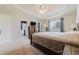 Spacious main bedroom featuring a tray ceiling, a large bed, and a carpeted floor at 15389 E 99Th Way, Commerce City, CO 80022