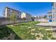 Large backyard with green grass, a tree, and a wood fence at 16006 E 97Th Pl, Commerce City, CO 80022