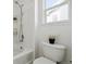 Bright bathroom featuring a walk-in shower, white tile, and modern fixtures for a clean and comfortable space at 16006 E 97Th Pl, Commerce City, CO 80022
