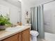 Bathroom with a shower-tub combo, a light-colored vanity, and decorative plants at 16006 E 97Th Pl, Commerce City, CO 80022