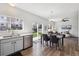 Bright dining area flows to the living room with hardwood floors and sliding glass doors to the yard at 16006 E 97Th Pl, Commerce City, CO 80022