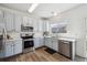 Charming kitchen featuring stainless steel appliances, white countertops and light blue cabinets at 16006 E 97Th Pl, Commerce City, CO 80022