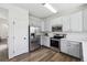 Kitchen featuring stainless steel appliances, white countertops and light blue cabinets at 16006 E 97Th Pl, Commerce City, CO 80022