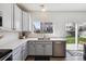 Bright kitchen featuring stainless steel appliances, white countertops and light blue cabinets at 16006 E 97Th Pl, Commerce City, CO 80022
