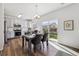 Bright dining area flows to the kitchen with hardwood floors and sliding glass doors to the yard at 16006 E 97Th Pl, Commerce City, CO 80022