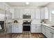 Kitchen featuring stainless steel appliances, white countertops and light blue cabinets at 16006 E 97Th Pl, Commerce City, CO 80022