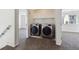 Upstairs laundry room with side-by-side washer and dryer, with connections and shelving at 16006 E 97Th Pl, Commerce City, CO 80022