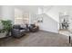 Living room with vaulted ceilings, carpeted floors, two large windows and neutral paint at 16006 E 97Th Pl, Commerce City, CO 80022