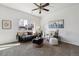 Sun-filled living room features neutral tones, a large window, and stylish decor at 16006 E 97Th Pl, Commerce City, CO 80022