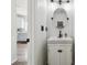 Charming powder room with a stylish vanity, a framed mirror, and modern fixtures at 16006 E 97Th Pl, Commerce City, CO 80022
