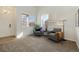 Light-filled sitting room with cozy armchairs, perfect for enjoying peaceful moments and reading at 16006 E 97Th Pl, Commerce City, CO 80022