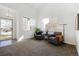 Welcoming sitting room filled with natural light and comfortable seating for relaxation and conversation at 16006 E 97Th Pl, Commerce City, CO 80022