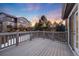 A view from the deck of a large backyard surrounded by mature trees and neighboring houses at 11053 Meadowvale Cir, Highlands Ranch, CO 80130