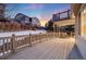 Multi level deck and fenced in yard with snow covered ground at 11053 Meadowvale Cir, Highlands Ranch, CO 80130