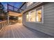 The deck features wood flooring with a neutral gray stain and large windows into the home at 11053 Meadowvale Cir, Highlands Ranch, CO 80130