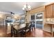 Dining area featuring a stone fireplace, access to the back deck, and seamless flow into the kitchen at 11053 Meadowvale Cir, Highlands Ranch, CO 80130