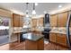 Well-lit kitchen featuring granite countertops, modern appliances, and a kitchen island at 11053 Meadowvale Cir, Highlands Ranch, CO 80130