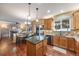 Open-concept kitchen with granite countertops, an island, stainless appliances, and natural wood cabinetry at 11053 Meadowvale Cir, Highlands Ranch, CO 80130