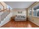 Cozy living room featuring hardwood floors, a staircase, and natural light at 11053 Meadowvale Cir, Highlands Ranch, CO 80130