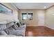 Bright living room with hardwood floors, a comfortable couch, and natural light from the windows at 11053 Meadowvale Cir, Highlands Ranch, CO 80130