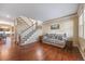 Comfortable living area with hardwood floors, a staircase, and view into dining area at 11053 Meadowvale Cir, Highlands Ranch, CO 80130