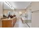 Bathroom featuring dual sinks, a soaking tub, and a glass-enclosed shower at 11053 Meadowvale Cir, Highlands Ranch, CO 80130