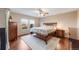 Bright main bedroom featuring a ceiling fan, hardwood floors, and a comfortable bed at 11053 Meadowvale Cir, Highlands Ranch, CO 80130