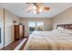 Sunlit main bedroom featuring hardwood floors, a ceiling fan, and bright windows at 11053 Meadowvale Cir, Highlands Ranch, CO 80130