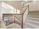 Carpeted staircase with a white railing and wooden banister leading to the upper level at 11053 Meadowvale Cir, Highlands Ranch, CO 80130