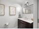 Modern half-bathroom with a pedestal sink, mirror, and contemporary decor at 1891 Curtis St # 1812, Denver, CO 80202