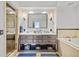 Elegant bathroom featuring a double vanity with a large mirror and a walk-in shower at 1891 Curtis St # 1812, Denver, CO 80202