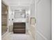 Modern bathroom with a single vanity, tiled floors, and glass enclosed shower at 1891 Curtis St # 1812, Denver, CO 80202