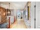 Bright hallway with stone accent wall, unique lighting fixture, and outside view at 1891 Curtis St # 1812, Denver, CO 80202
