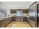 Modern kitchen featuring stainless steel appliances, stone backsplash, and hardwood floors at 1891 Curtis St # 1812, Denver, CO 80202