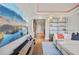 Elegant living room featuring a large screen TV, modern shelving, and comfortable seating with vibrant decor at 1891 Curtis St # 1812, Denver, CO 80202