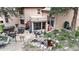 Backyard featuring outdoor seating, dining, stone water feature, and a hot tub, surrounded by mature landscaping at 974 Spring Ranch Dr, Golden, CO 80401