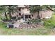 Backyard with a multi-level patio, landscaping, and seating areas amidst the trees at 974 Spring Ranch Dr, Golden, CO 80401