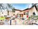 Backyard patio featuring a hot tub, outdoor dining and seating, and colorful outdoor rug at 974 Spring Ranch Dr, Golden, CO 80401
